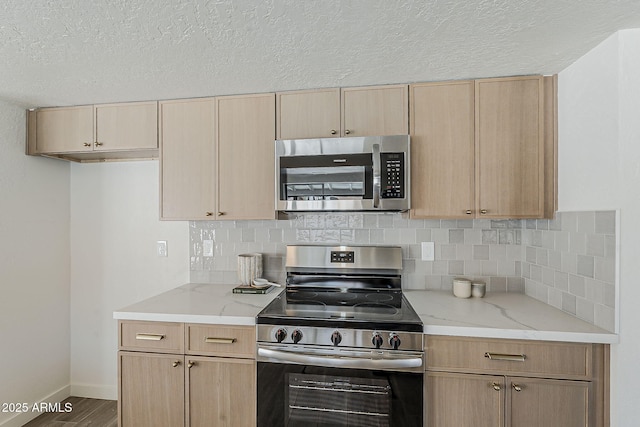 2307 W Nido Ave, Mesa, AZ 85202 - kitchen with stainless steel appliances, light brown cabinetry, light stone counters, decorative backsplash, and a textured ceiling
