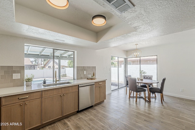 2307 W Nido Ave, Mesa, AZ 85202 - kitchen with a sink, dishwasher, tasteful backsplash, a chandelier, and baseboards