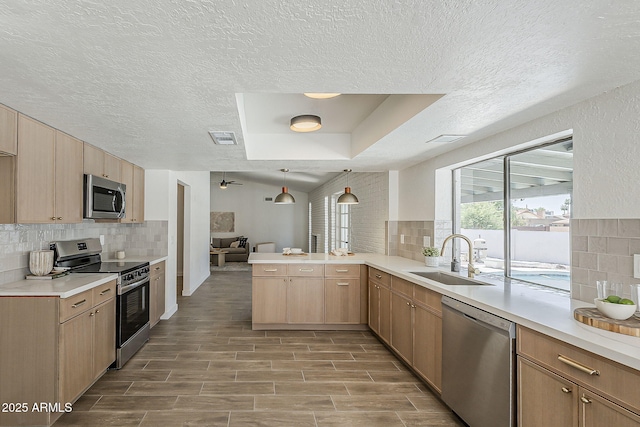 2307 W Nido Ave, Mesa, AZ 85202 - kitchen featuring stainless steel appliances, a sink, decorative backsplash, a textured ceiling, and light countertops