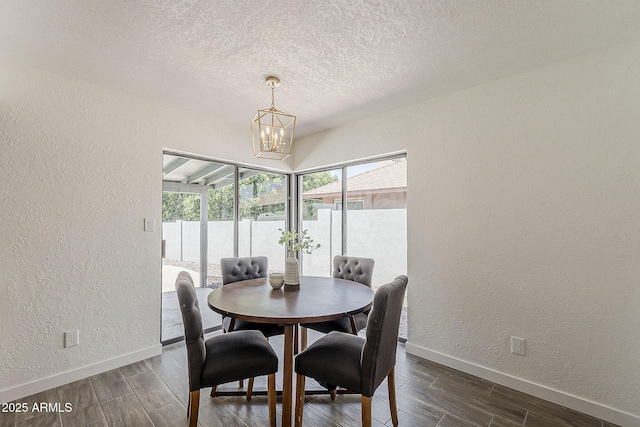 2307 W Nido Ave, Mesa, AZ 85202 - dining area with a textured wall, a chandelier, baseboards, dark wood-style flooring, and a textured ceiling