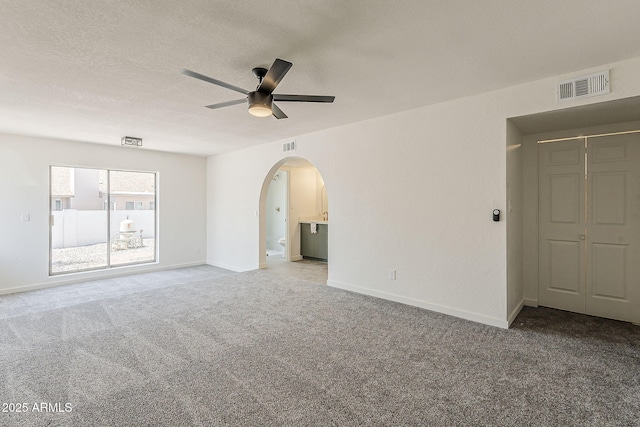 2307 W Nido Ave, Mesa, AZ 85202 - unfurnished room with a ceiling fan, carpet floors, arched walkways, baseboards, and a textured ceiling
