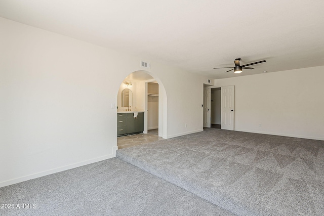 2307 W Nido Ave, Mesa, AZ 85202 - spare room with light carpet, a ceiling fan, arched walkways, baseboards, and a sink