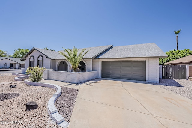 2307 W Nido Ave, Mesa, AZ 85202 - view of front of home featuring brick siding, driveway, an attached garage, and roof with shingles