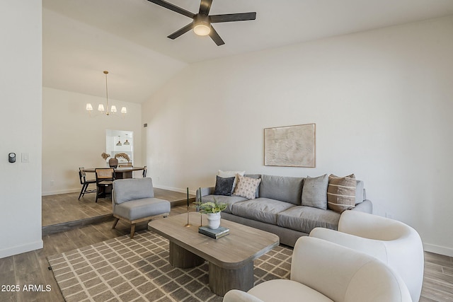 2307 W Nido Ave, Mesa, AZ 85202 - living room with ceiling fan, a chandelier, vaulted ceiling, wood finished floors, and baseboards