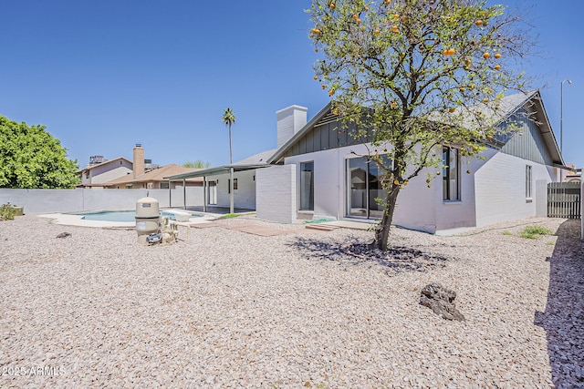 2307 W Nido Ave, Mesa, AZ 85202 - rear view of property with board and batten siding, a fenced backyard, a chimney, a patio, and brick siding