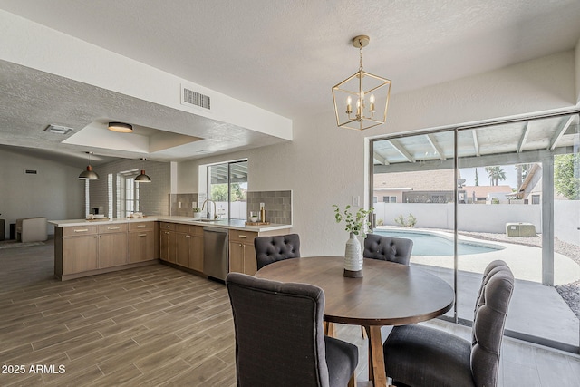 2307 W Nido Ave, Mesa, AZ 85202 - dining space featuring a textured ceiling, a chandelier, wood finished floors, and a textured wall