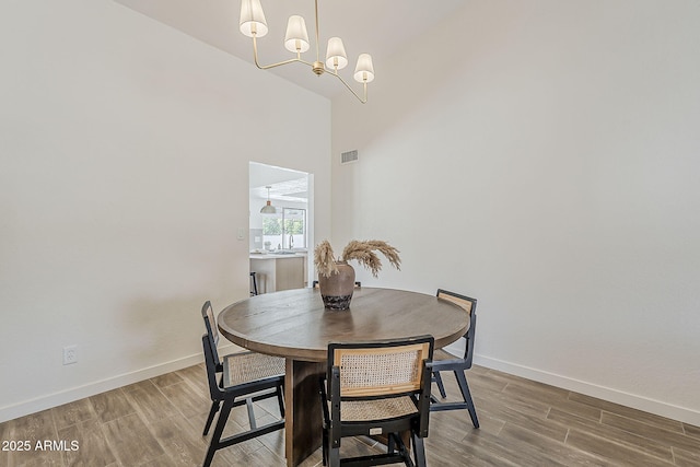 2307 W Nido Ave, Mesa, AZ 85202 - dining space with wood finished floors, baseboards, and a chandelier