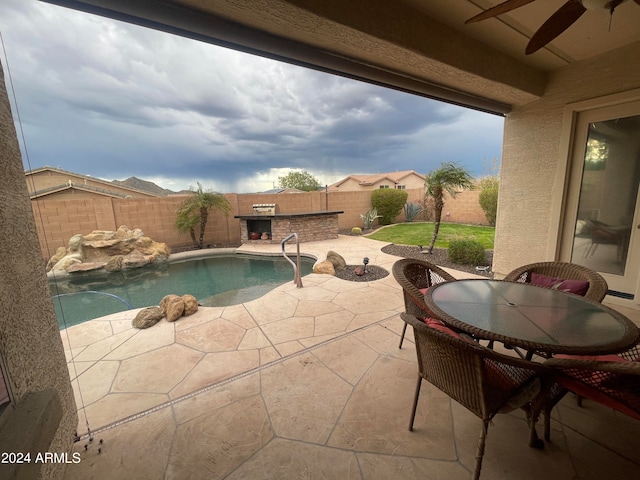 view of swimming pool featuring ceiling fan and a patio