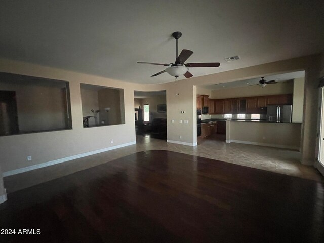 unfurnished living room featuring hardwood / wood-style floors and ceiling fan