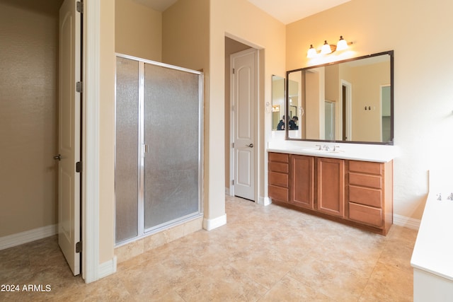 bathroom featuring vanity and a shower with door