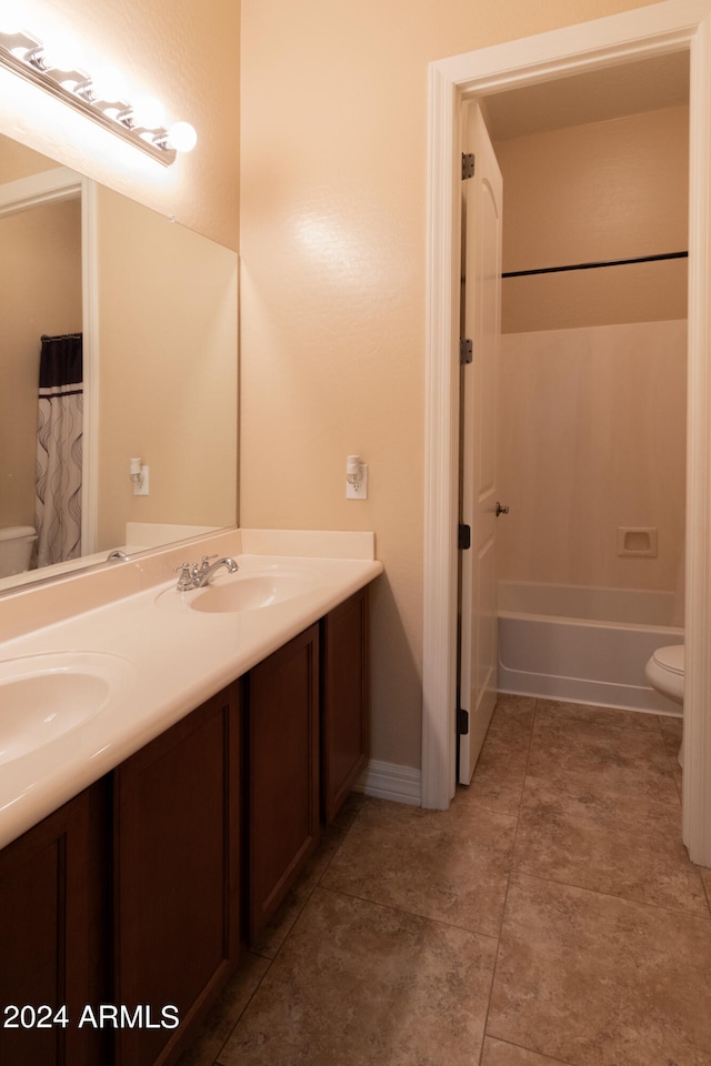 bathroom featuring tile patterned flooring, vanity, and toilet