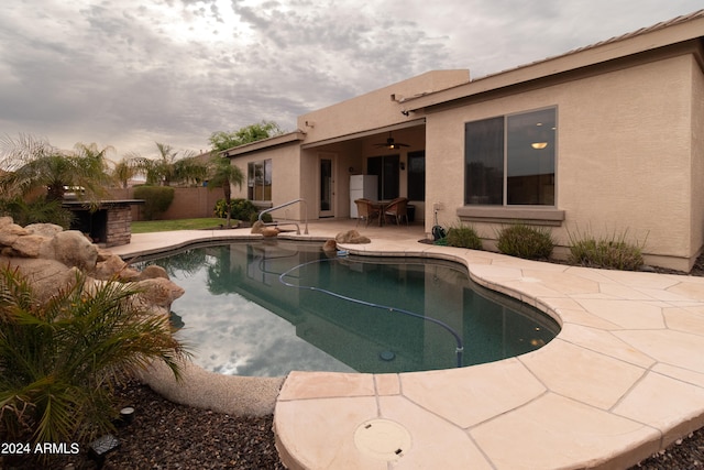 view of pool featuring ceiling fan and a patio