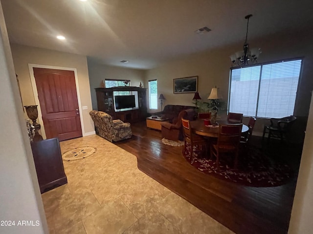 dining room with hardwood / wood-style floors and an inviting chandelier