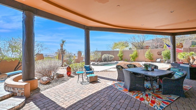 view of patio / terrace featuring a hot tub, outdoor dining area, and a fenced backyard