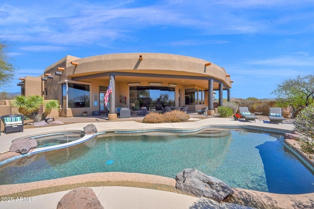 view of pool featuring a patio and a pool with connected hot tub