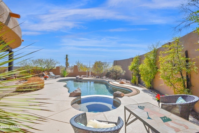 view of pool with a patio area, a fenced in pool, an in ground hot tub, and a fenced backyard