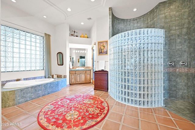 bathroom with tile patterned floors, visible vents, a garden tub, a walk in shower, and vanity