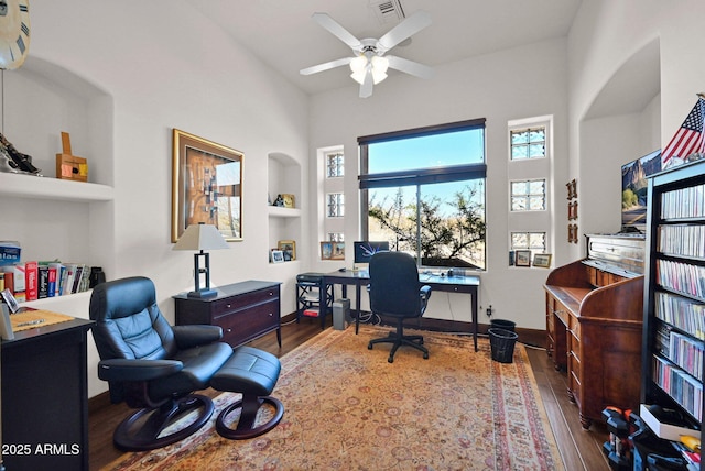 office space with a ceiling fan, wood finished floors, and baseboards