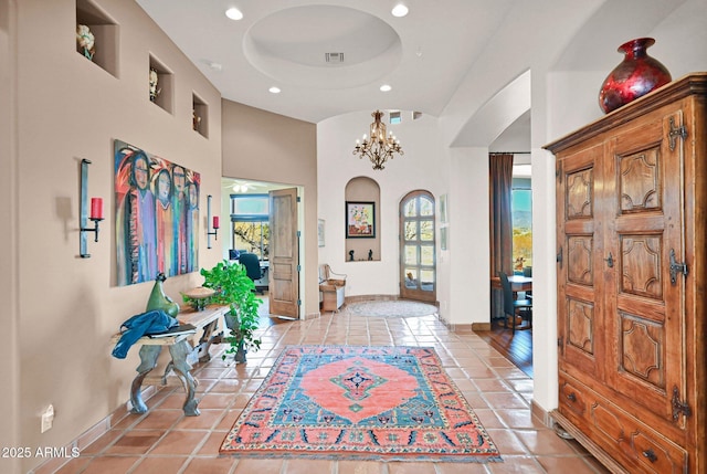 entrance foyer featuring recessed lighting, baseboards, an inviting chandelier, and light tile patterned flooring