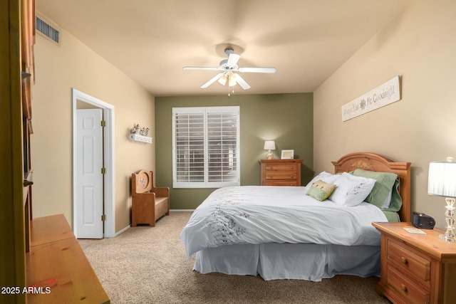 carpeted bedroom featuring visible vents, baseboards, and ceiling fan