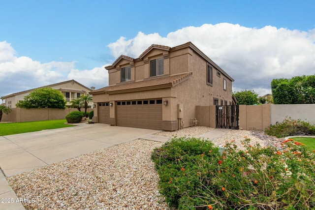 view of front of house featuring a gate, fence, an attached garage, stucco siding, and a tile roof