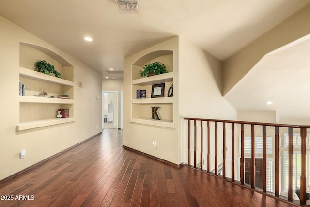 corridor featuring visible vents, recessed lighting, hardwood / wood-style flooring, and built in features