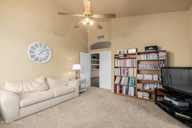 living area with visible vents, high vaulted ceiling, ceiling fan, and carpet floors