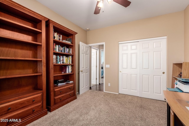 carpeted office space with ceiling fan