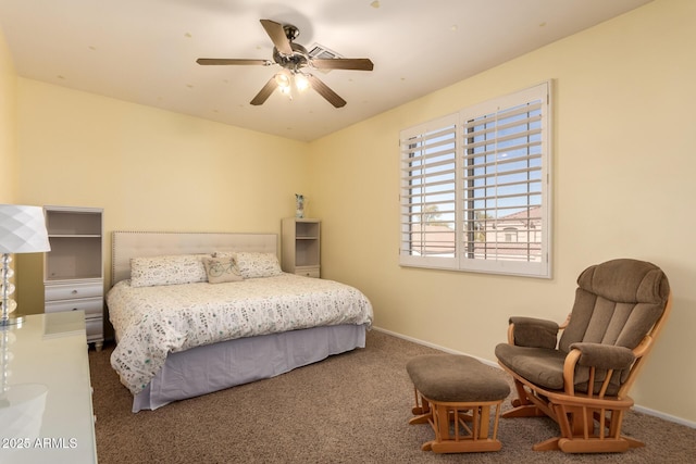 bedroom with a ceiling fan, baseboards, and carpet floors