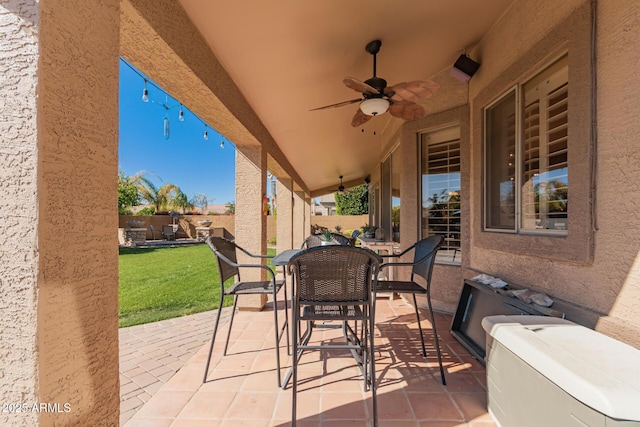 view of patio with a fenced backyard, outdoor dining space, and ceiling fan