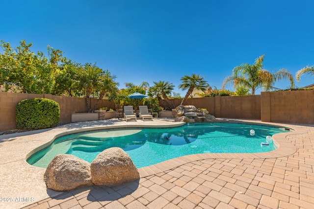 view of swimming pool with a patio area, a fenced backyard, and a fenced in pool