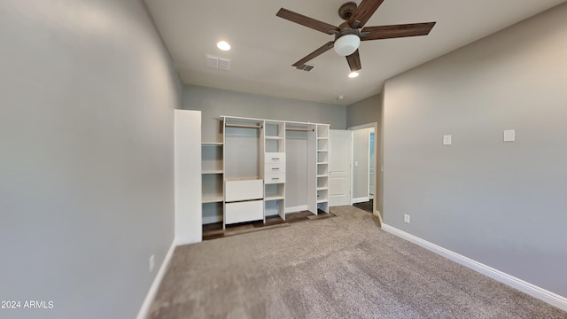 unfurnished bedroom with a closet, ceiling fan, and dark carpet