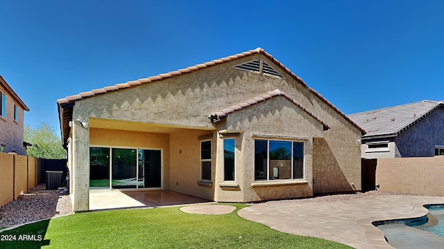 back of house featuring central AC, a patio, and a fenced in pool