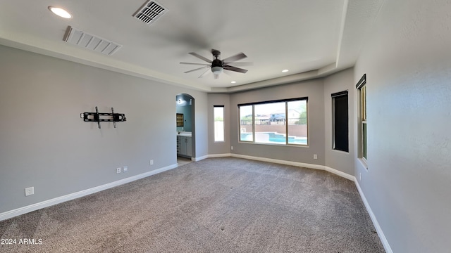 empty room with ceiling fan and carpet