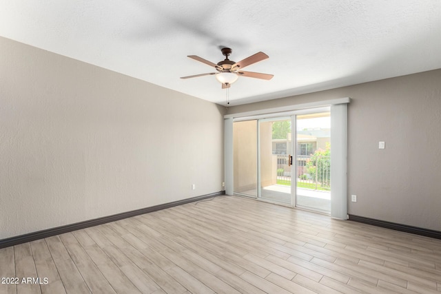 spare room featuring a textured ceiling, ceiling fan, and light hardwood / wood-style floors