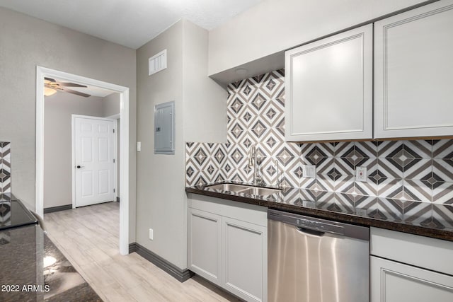 kitchen with dishwasher, white cabinetry, dark stone counters, ceiling fan, and electric panel