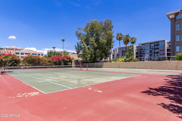 view of tennis court with basketball hoop