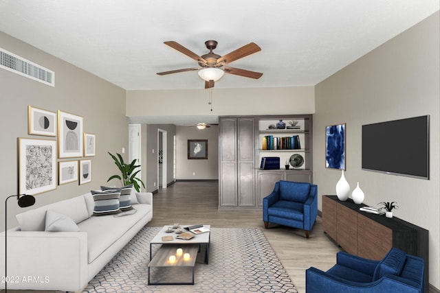 living room with ceiling fan and light hardwood / wood-style flooring