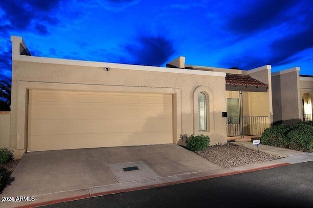 adobe home featuring a garage