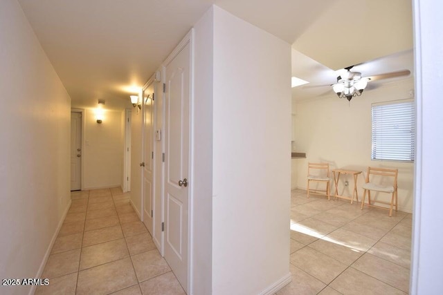 hall featuring light tile patterned flooring