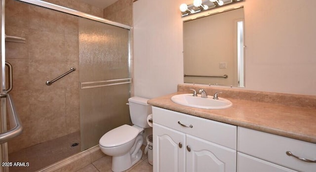 bathroom with tile patterned floors, walk in shower, vanity, and toilet