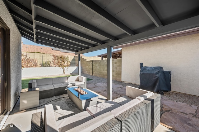 view of patio featuring grilling area and an outdoor living space with a fire pit