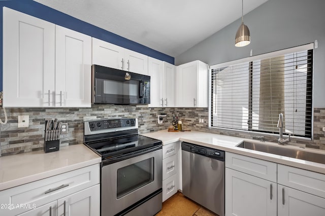 kitchen with white cabinets, backsplash, sink, and stainless steel appliances