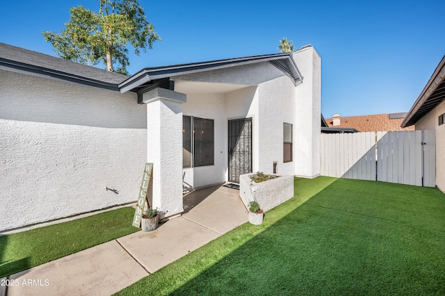 doorway to property with a yard