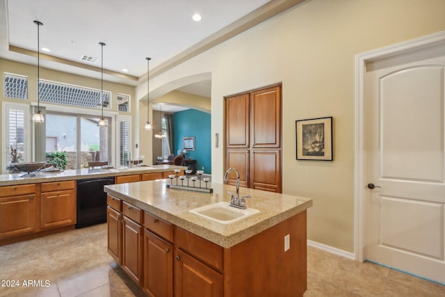 kitchen with dishwasher, sink, hanging light fixtures, an island with sink, and light tile patterned flooring