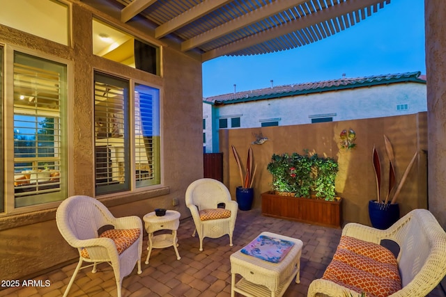 view of patio featuring visible vents and fence