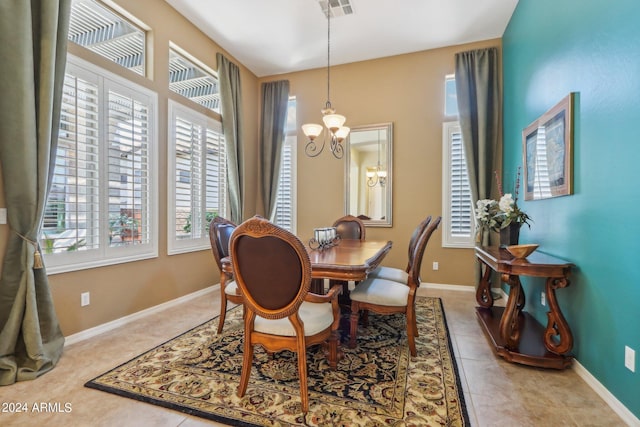 dining room with light tile patterned floors, a wealth of natural light, and a chandelier