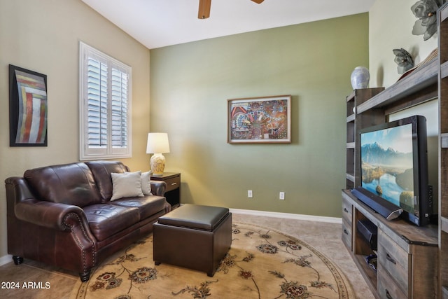 living room featuring light carpet, ceiling fan, and baseboards