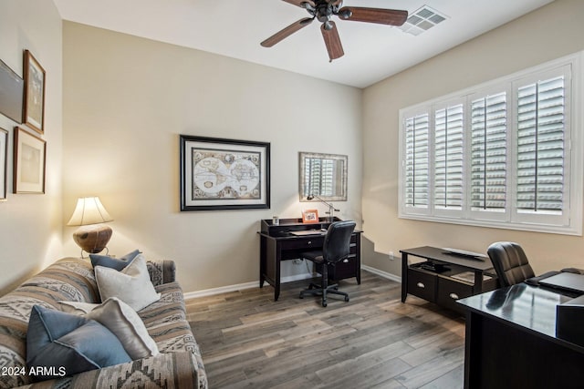 office space with baseboards, dark wood-type flooring, visible vents, and a ceiling fan