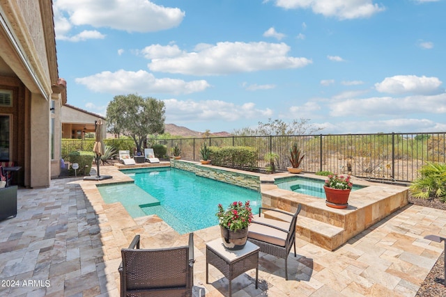 view of swimming pool with a fenced backyard, a patio, a fenced in pool, and an in ground hot tub